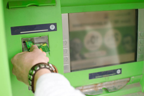 Young man is using cash machine - Fotoğraf, Görsel