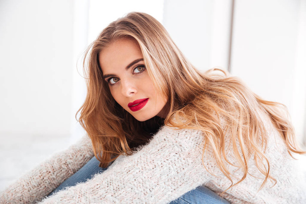 Portrait of beautiful blonde woman wearing sweater and red lipstick - Fotografie, Obrázek