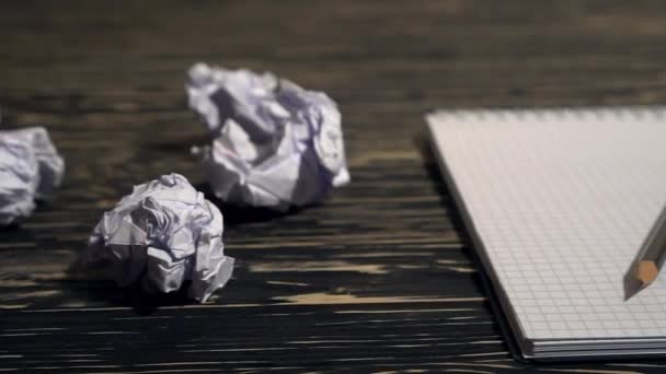 Person throwing a lot of crumpled paper on a desk, close-up. - Footage, Video