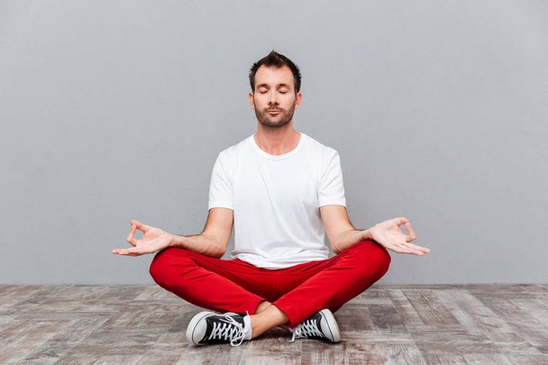 Man in casual cloth sitting in lotus position - Foto, Imagem