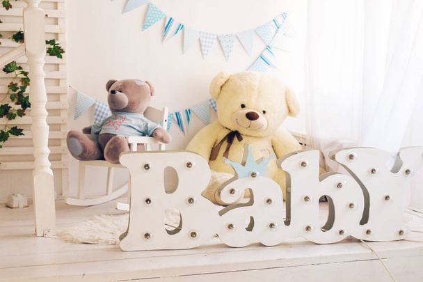 White bedroom with blue decorations designed and teddy bear ideal for both boys and girls - Photo, Image