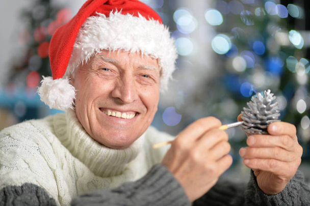 Senior man in Santa hat - Фото, изображение