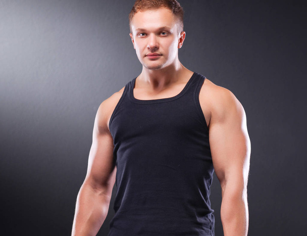 Handsome muscular man working out with dumbbells - Zdjęcie, obraz