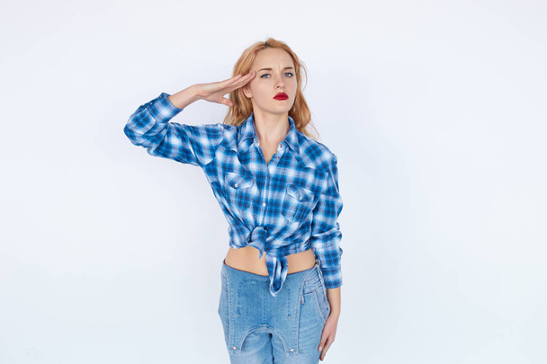 Confident woman in casual clothes saluting - 写真・画像