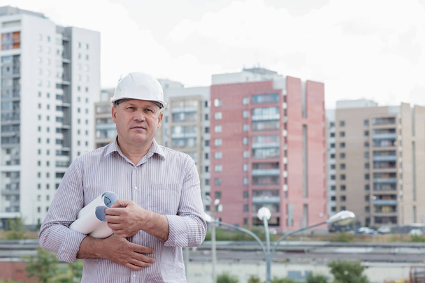 An engineer with construction plans - Fotoğraf, Görsel