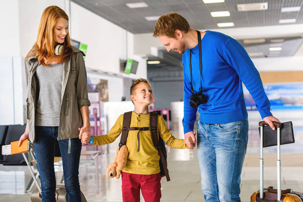 Happy family with suitcases in airport - Foto, immagini
