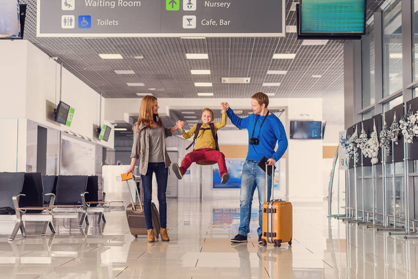 Happy family with suitcases in airport - Foto, Imagen