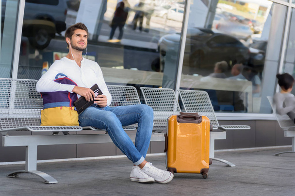 Cheerful young guy preparing for trip - Photo, image