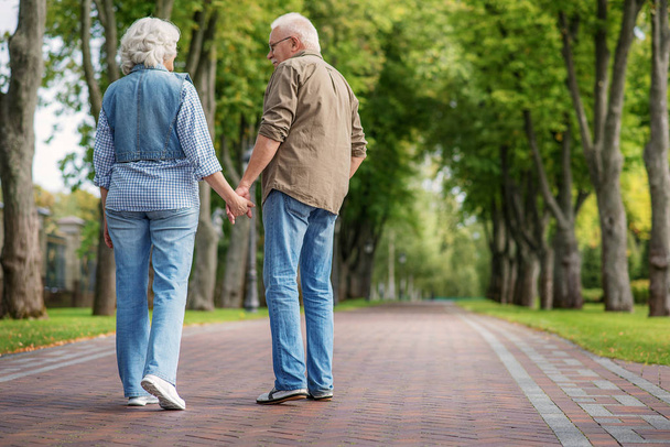 Happy mature man and woman having walk together - Photo, Image