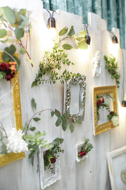 vintage frames and flowers hanging on the wall. - Photo, Image