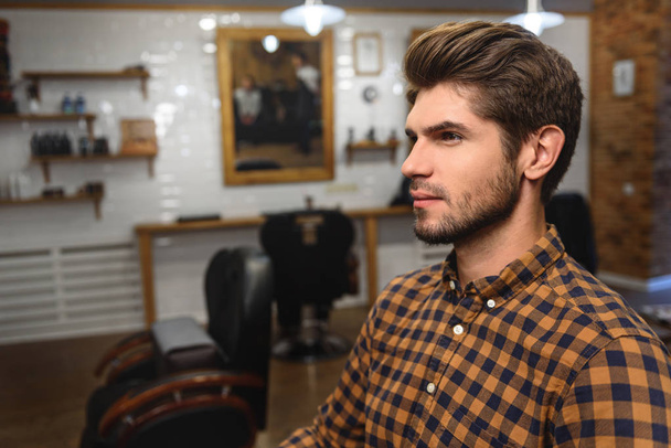 face of young man at barbershop - 写真・画像