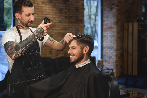 tattooed hair stylist working with a guy - Zdjęcie, obraz