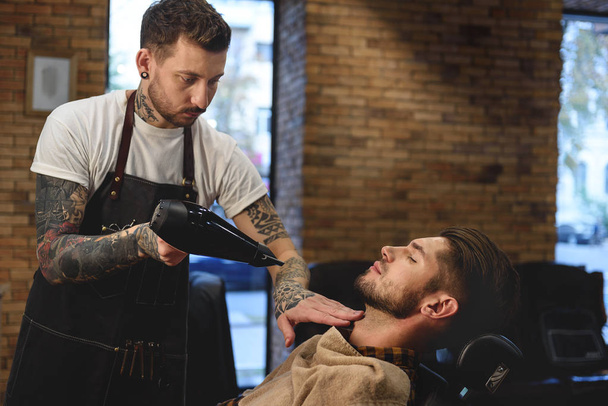 professional hairdresser working with hairdryer - Foto, imagen