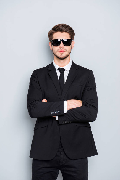 Portrait of bodyguard in black suit and glasses with crossed han - Foto, imagen