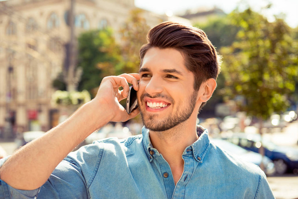 Close up photo of a handsome man talk on phone and walk  street - Foto, Bild