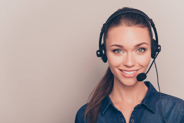 Beautiful consultant of call center in headphones on gray backgr - Foto, imagen