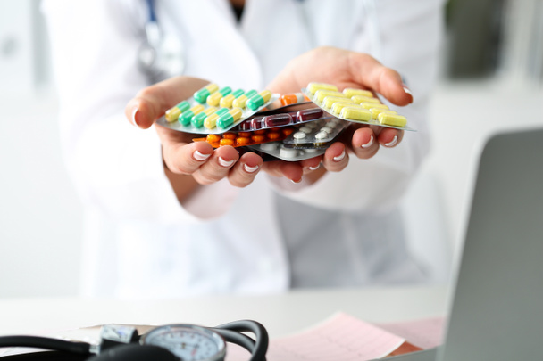 Female doctor hand holding pack of different tablet blisters - Φωτογραφία, εικόνα