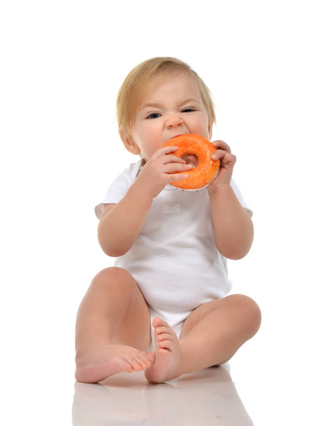 Infant child baby boy toddler eat sweet donut candy fast food  - Photo, Image