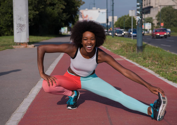 sporty young african american woman stretching  - Фото, зображення