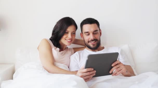 smiling couple in bed with tablet pc computer - Footage, Video