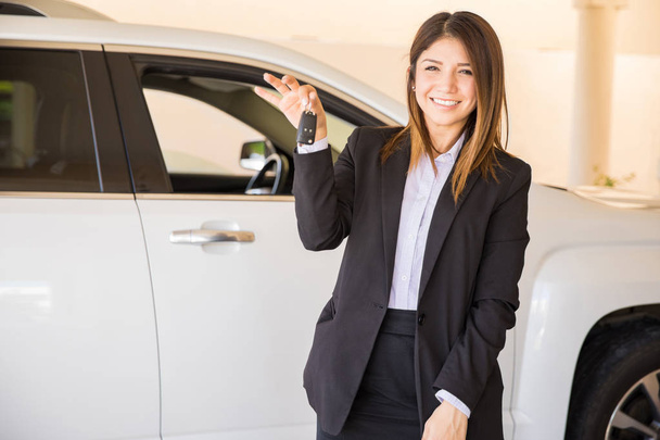 brunette in a suit handing over the keys  - Photo, image