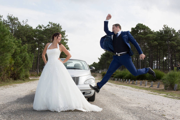 Bride and groom jump high on the country - Фото, изображение