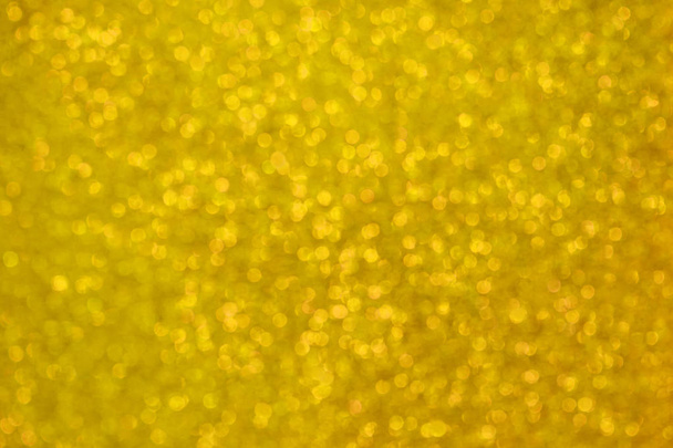 黄金色にキラキラのぼやけキラキラ テクスチャ。抽象的な背景のボケ味  - 写真・画像