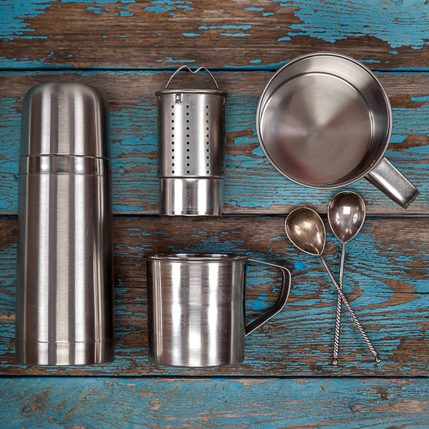Metal thermos, strainer, mugs and spoons. - Fotó, kép