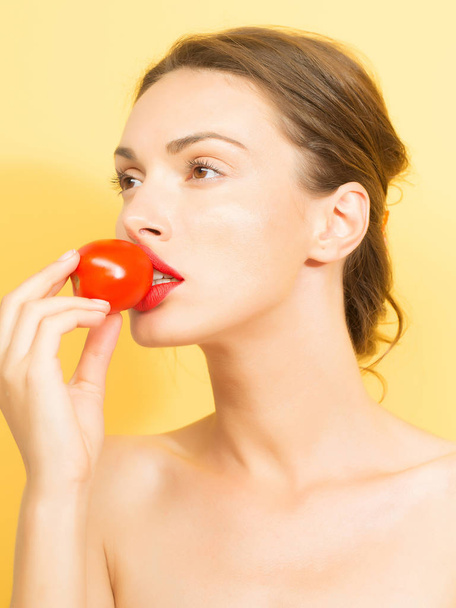 pretty girl with red tomato - 写真・画像