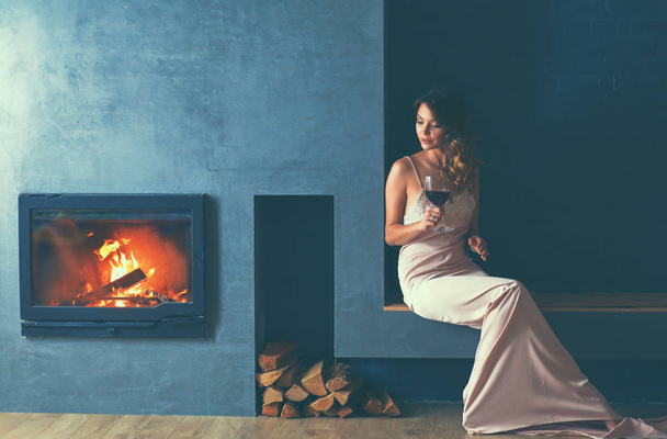 Sexy girl in front of the fireplace - Zdjęcie, obraz