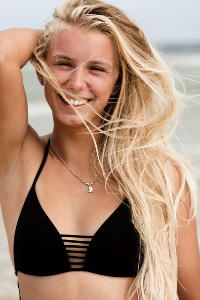 girl with blonde hair at the beach - Фото, зображення