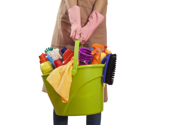 Young woman with cleaning supplies on white background - Fotoğraf, Görsel