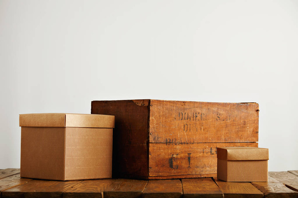Blank corrugated cardboard boxes with vintage wooden box - 写真・画像