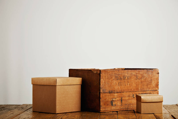 Blank corrugated cardboard boxes with vintage wooden box - Foto, Imagen