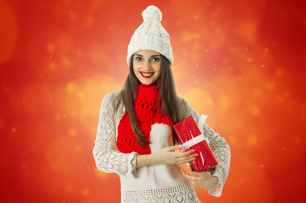 woman in warm sweater and red scarf - 写真・画像