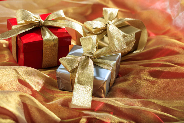 Gift boxes on a golden satin background - Foto, immagini