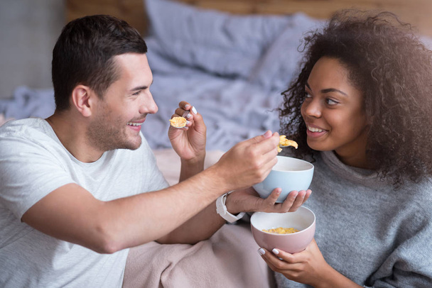 couple feeding each other with cereals - 写真・画像