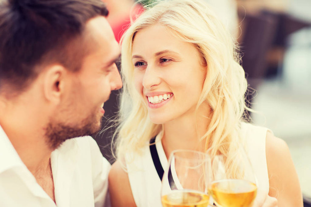happy couple clinking glasses at restaurant lounge - Фото, изображение