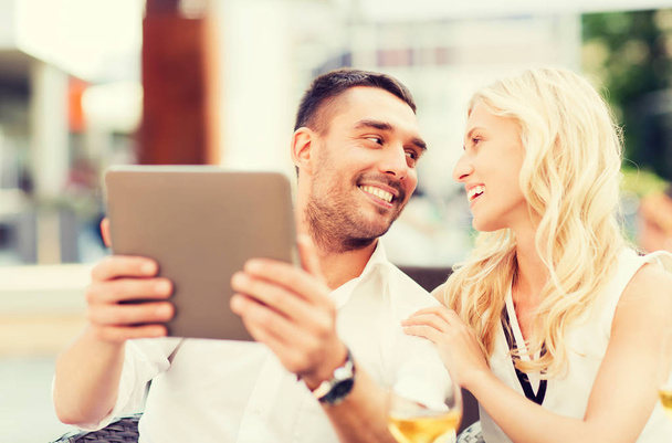 happy couple with tablet pc at restaurant lounge - Fotó, kép