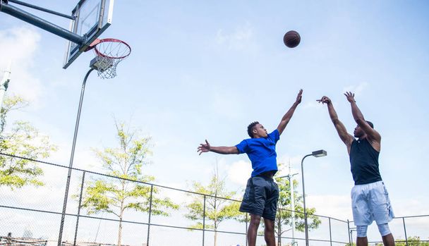 Basketball players training on court - Foto, Imagen