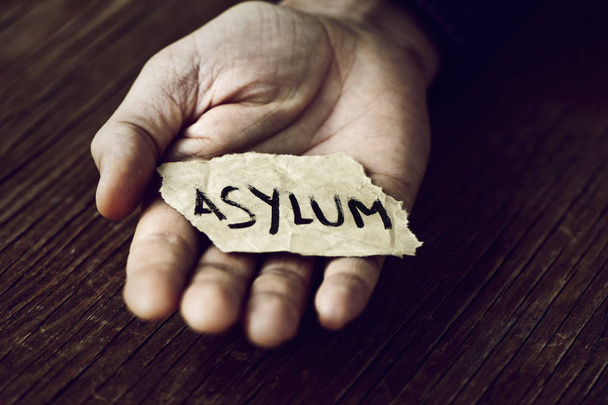 piece of paper with the word asylum - Photo, Image