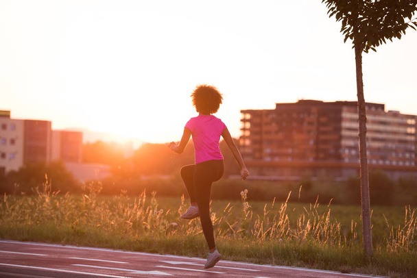 a young African American woman jogging outdoors - Photo, Image