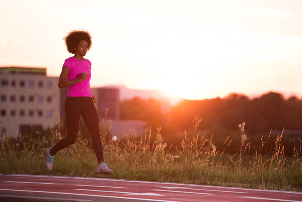 a young African American woman jogging outdoors - Φωτογραφία, εικόνα