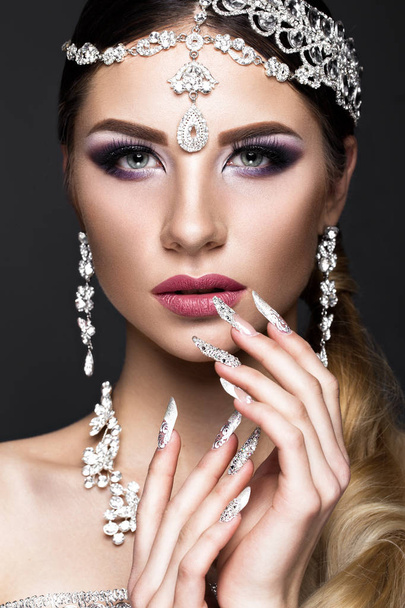 Beautiful girl in image of Arab bride with expensive jewelry, oriental make-up and bridal manicure. beauty face. - Foto, immagini