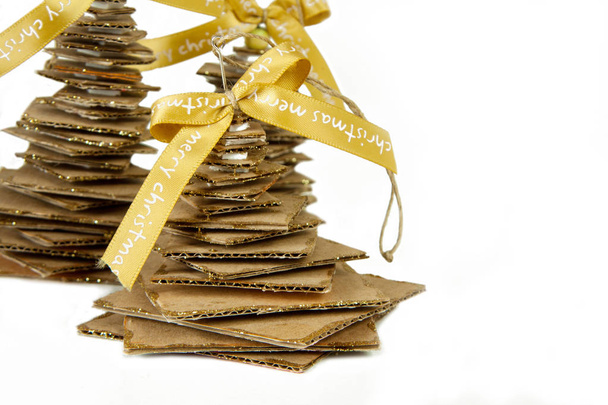 Golden ribbon and cardboard handmade Christmas tree isolated on  - Foto, Bild
