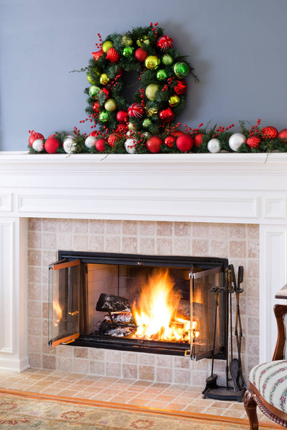 Christmas fireplace with baubles and blazing fire - Valokuva, kuva