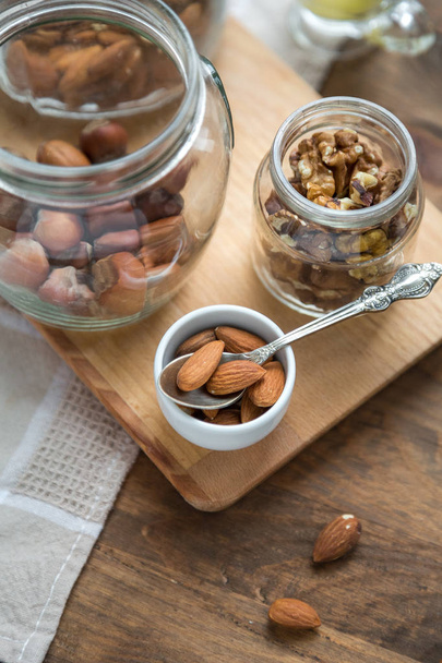 Assorted nuts: walnuts, almonds, hazelnuts and honey - Valokuva, kuva