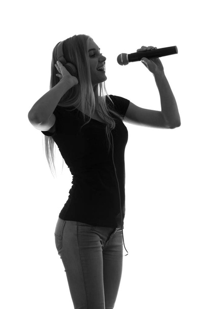 portrait of a beautiful woman in headphones and with a microphone - Valokuva, kuva
