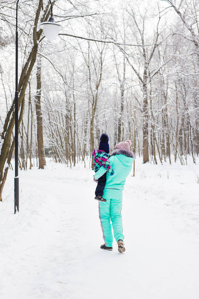 Happy family. Mother and child girl on a winter walk in nature. - Foto, imagen