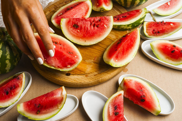 Slices of watermelon. Children's hands cooking fruit salad. Top view - Photo, Image